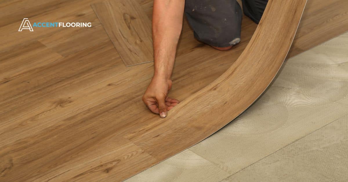 Contractor installing new hardwood flooring in a modern home