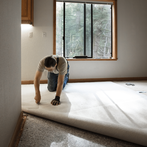 Professional carpet installer fitting new carpet in Salt Lake City home